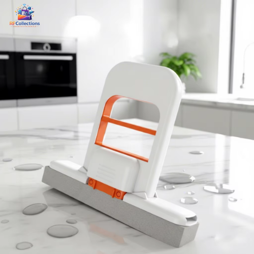 Self squeezing mini mop with foldable handle and orange sponge head cleaning water on kitchen countertop