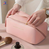 Large capacity travel makeup and cosmetic storage bag with compartments, waterproof PU leather design and portable handle for beauty essentials storage.